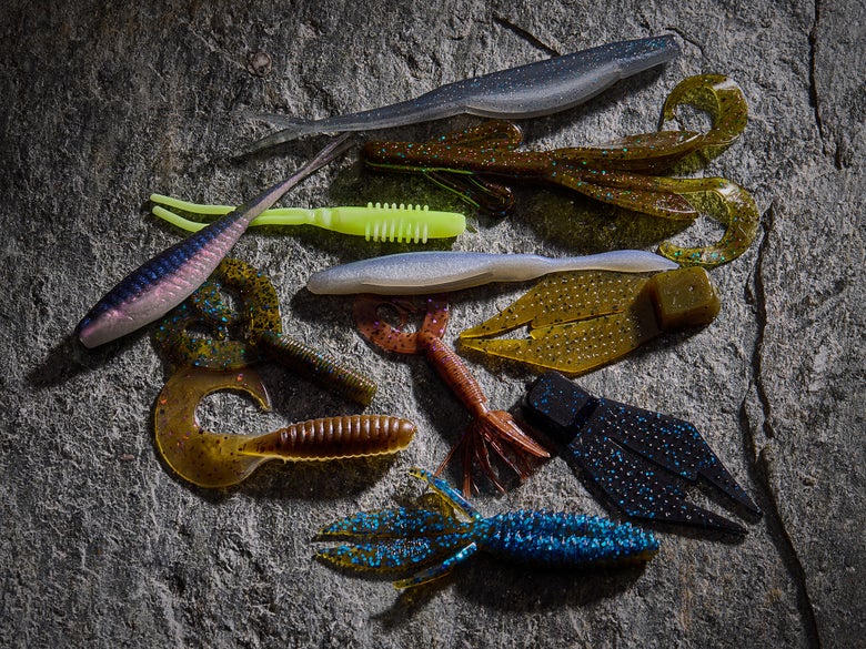 Soft plastic bass baits on a rock
