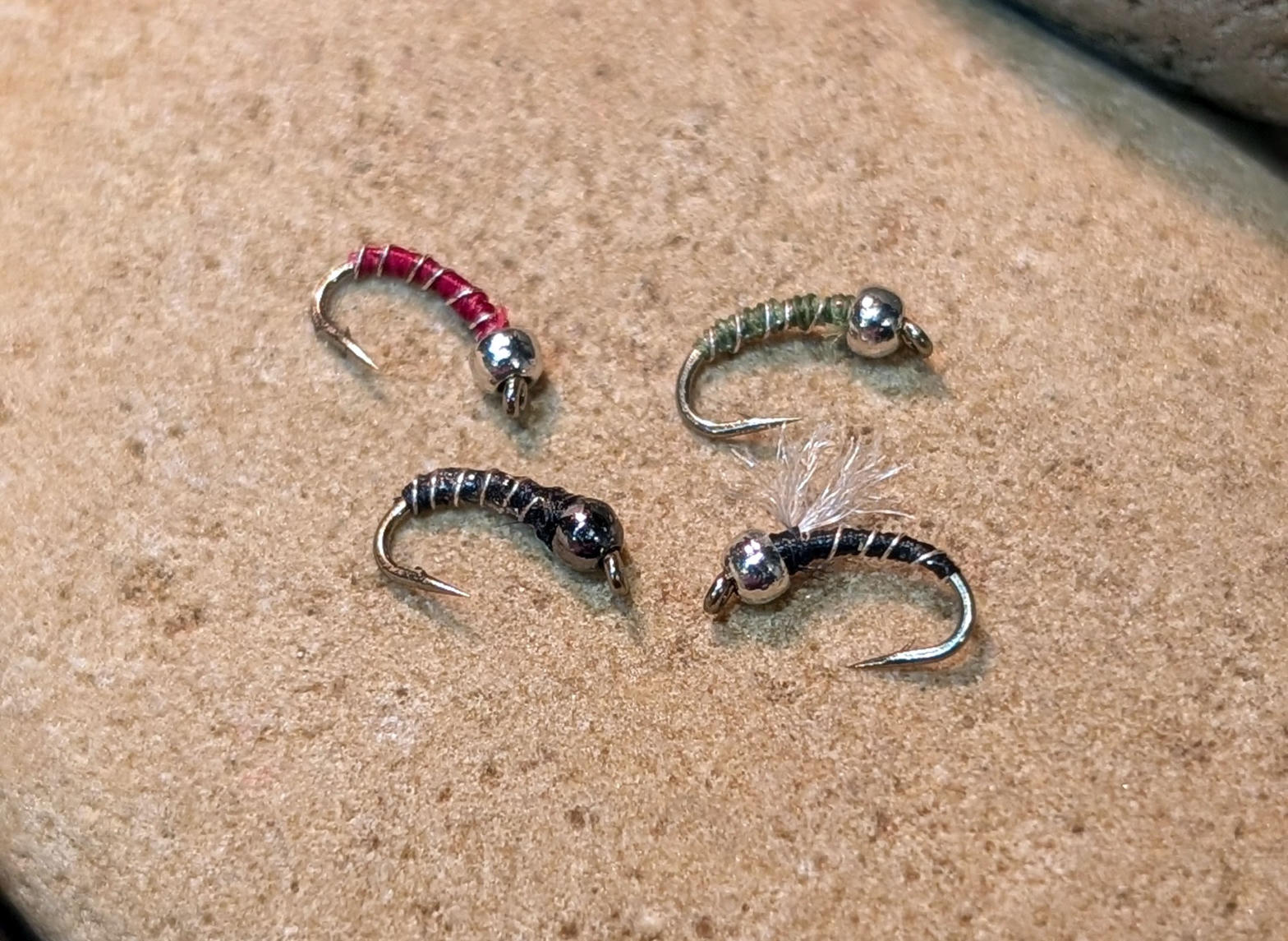Zebra midge flies on a river stone