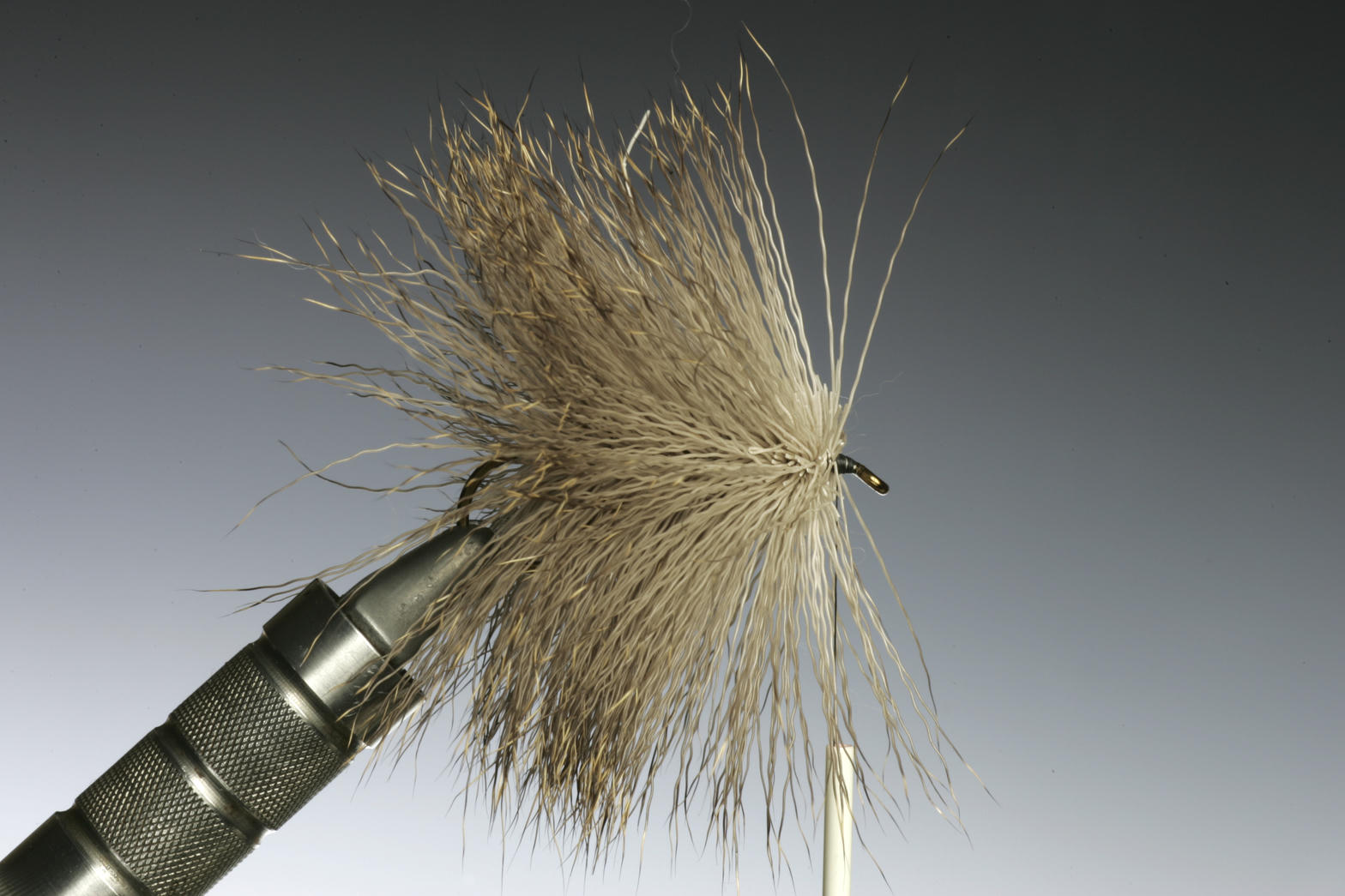 Deer hair spun on a hook in a vise